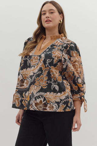 Woman wearing a floral blouse with a plain background
