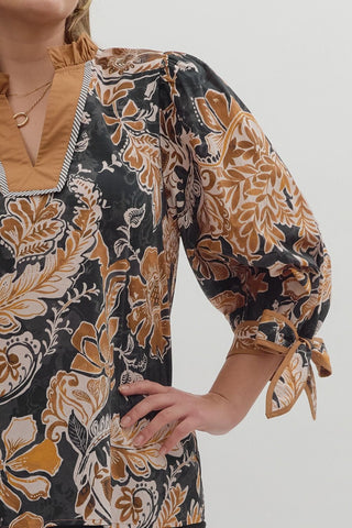 Person wearing a floral apron with a neutral background