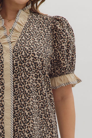 Leopard print dress with beige accents on a plain background