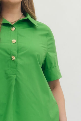 Green dress with floral buttons on a plain background