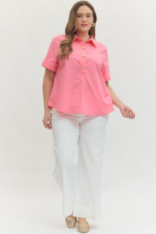 Woman wearing a pink shirt and white pants on a white background