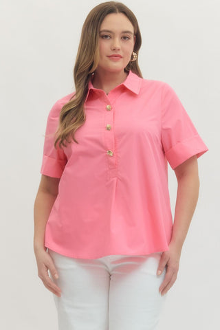 Woman wearing a pink shirt with gold buttons on a white background