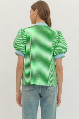 Person wearing a green and white striped shirt with puffed sleeves on a plain background