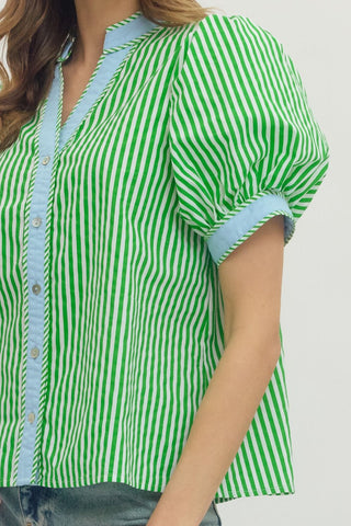 Green and white striped shirt with blue trim on a plain background