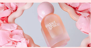 Pink bottle labeled 'sweet grace' surrounded by pink petals on a light gray background