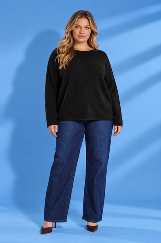 Black long sleeve top with a relaxed fit, round neckline, dropped shoulders, and center seam detail.