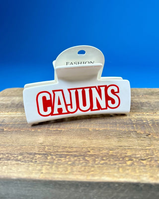 White oversized Cajuns claw hair clip with bold red lettering, durable spring hinge, and strong grip teeth for secure