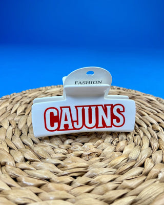 White oversized Cajuns claw hair clip with bold red lettering, durable spring hinge, and strong grip teeth for secure