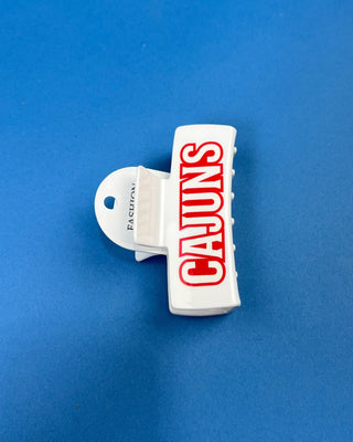 White oversized Cajuns claw hair clip with bold red lettering, durable spring hinge, and strong grip teeth for secure eve