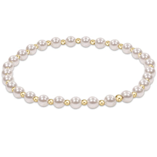 Pearl bracelet with gold accents on a white background