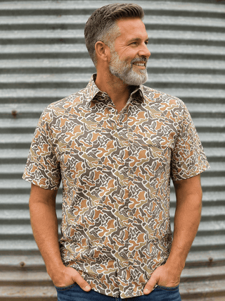 Duck Camo Polo featuring a duck camo print, stretch performance fabric, polo collar, and breathable all-day comfort.
