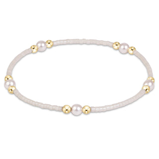 Enewton Hope Purpose Pearl Milkshake Bracelet against a solid blue background. 