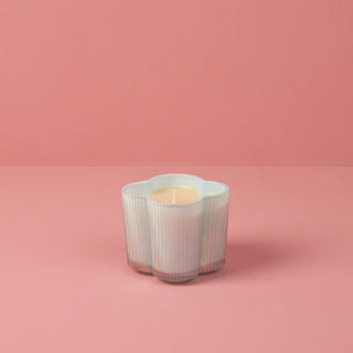 Decorative candle holder with a candle on a pink background