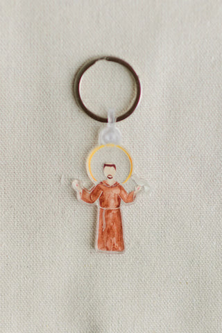 Keychain with a religious figure design on a light fabric background