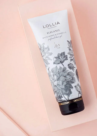 Lollia Elegance perfume bottle with floral design on a pink background