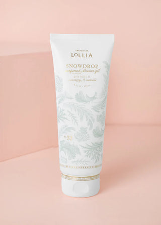 Tube of Lollia Snowdrop shower gel on a pink background