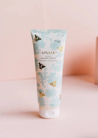 Lollia tube of sugar scrub with floral design on a pink background