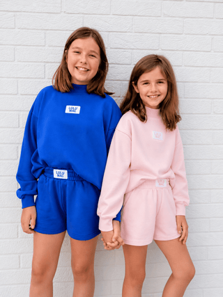 Youth Cloud Soft Shorts featuring a cotton blend, terry interior, elastic waistband, pockets, and relaxed fit.