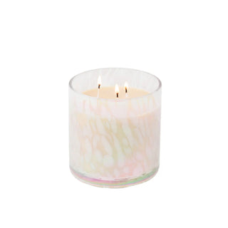 Candle in a glass container with a marbled design on a white background
