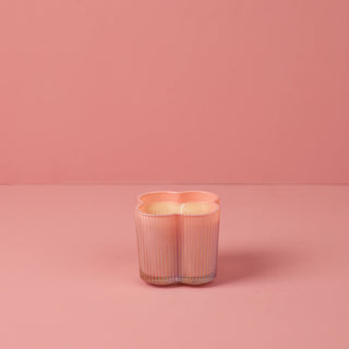 Pink ribbed vase on a pink background