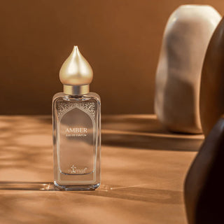 Amber eau de parfum bottle on a wooden surface with a warm background