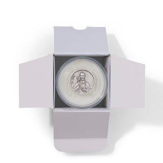 Round silver medallion with a face design in an open white box on a white background
