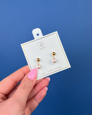 eNewton Classic 8mm Ball Drop Stud Pearl Earrings in classic gold featuring polished 8mm gold ball studs with elegant pearl drop accents and secure post backs displayed on an eNewton jewelry card.