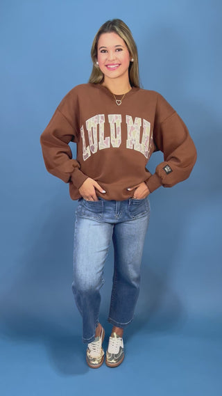 a brown crewneck sweatshirt with LULU MAC on sweatshirt.