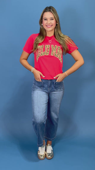 a red graphic t-shirt with leopard print lettering that reads 'LULU MAC"