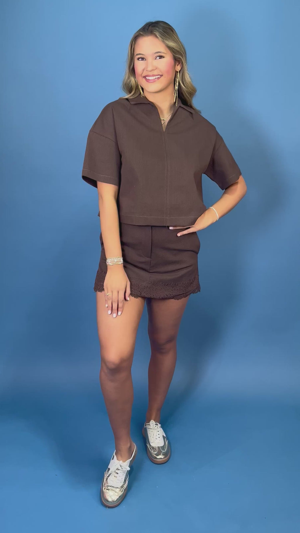 Chocolate brown collared top with short sleeves, paired with a matching lace-trim mini skort.