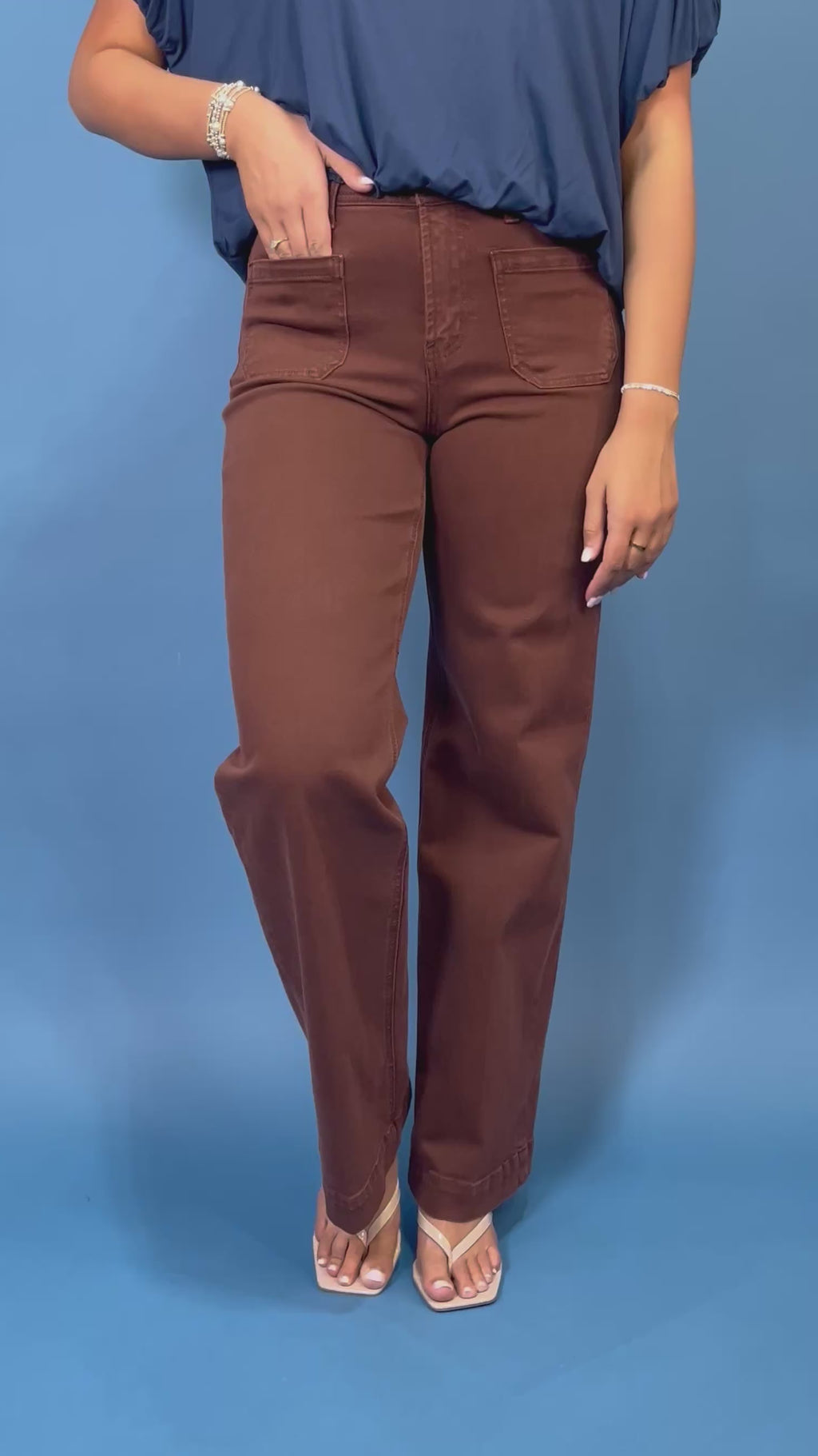 Chocolate brown high-rise wide leg jeans with front patch pockets, a flattering structured fit, and full-length silhouette.