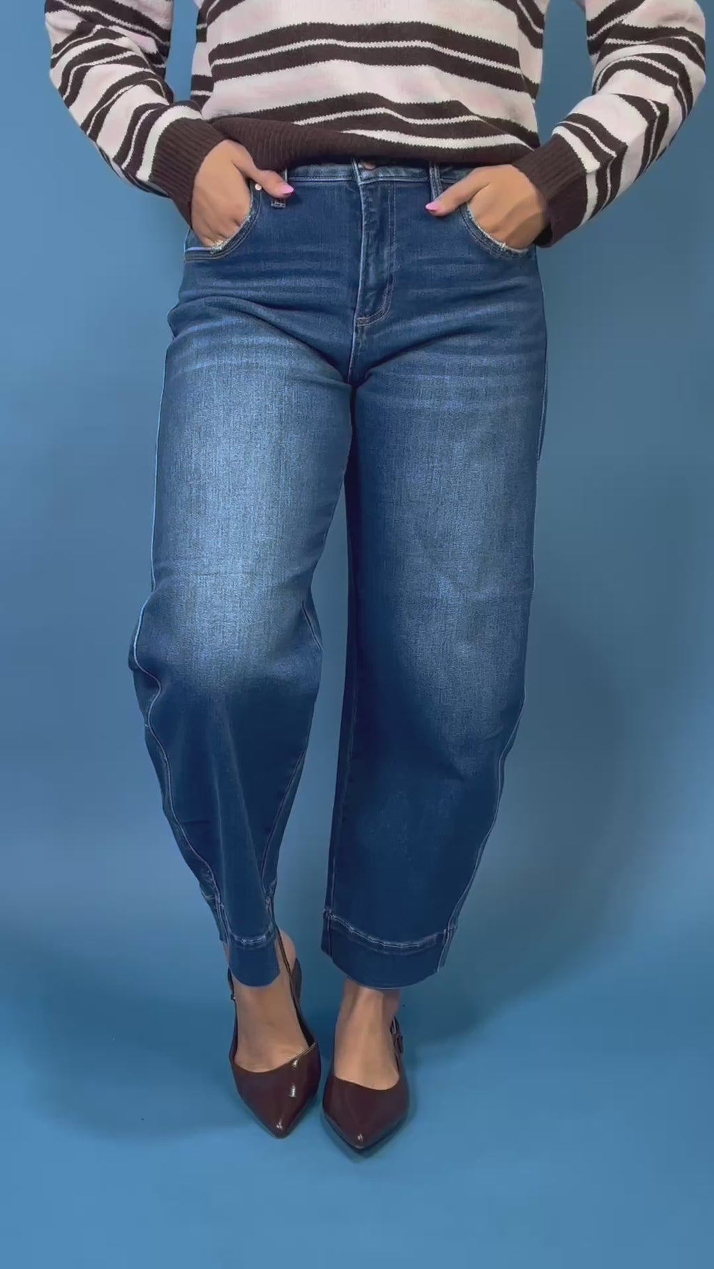 Dark wash high rise wide leg crop jeans with subtle fading and seamed cuff hem detail.