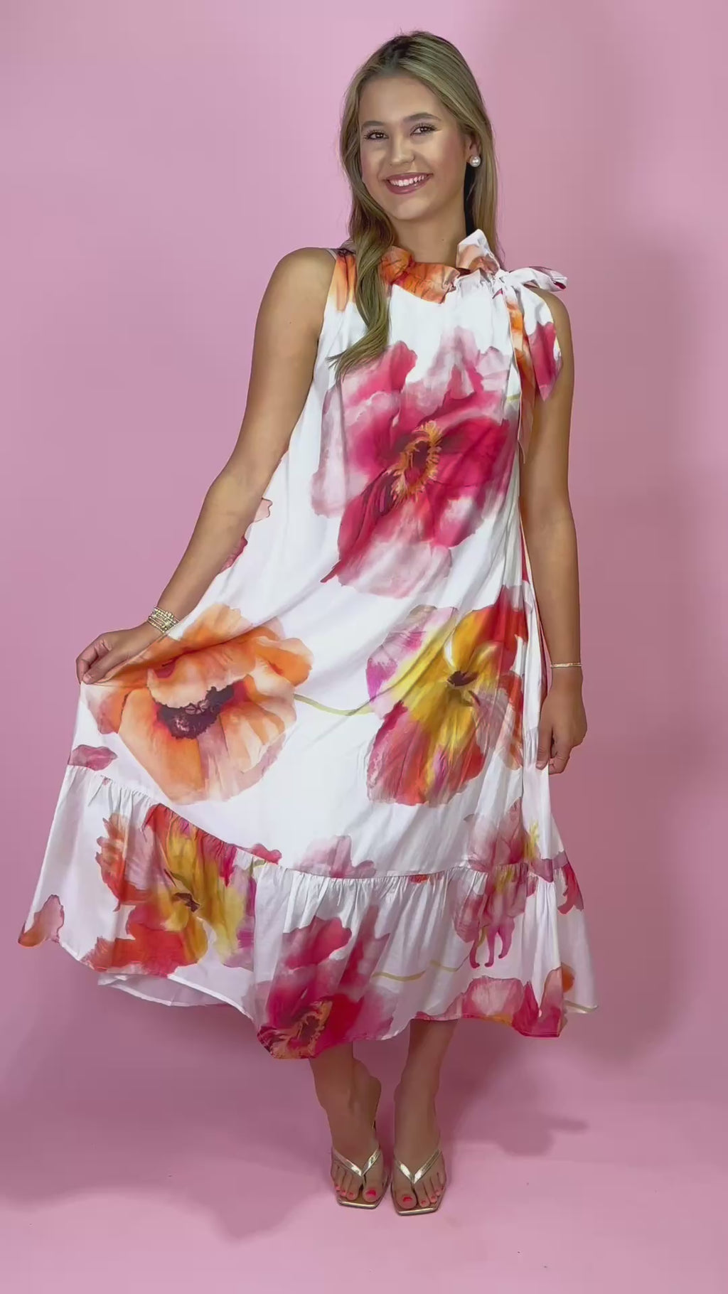 Woman wearing a floral top with a pink background