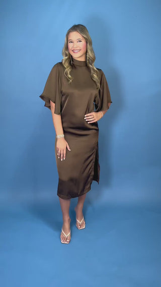 Chocolate brown satin midi dress with mock neckline, flutter sleeves, relaxed silhouette, and side slit detail.
