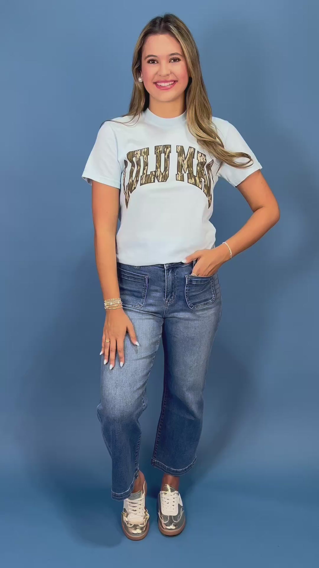  a light blue short-sleeve t-shirt with 'LULU MAC' printed across the chest in a camouflage pattern