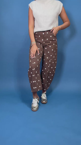 Chocolate brown high-rise cropped wide leg jeans with an allover ivory polka dot print, front pockets, and seam detailing.