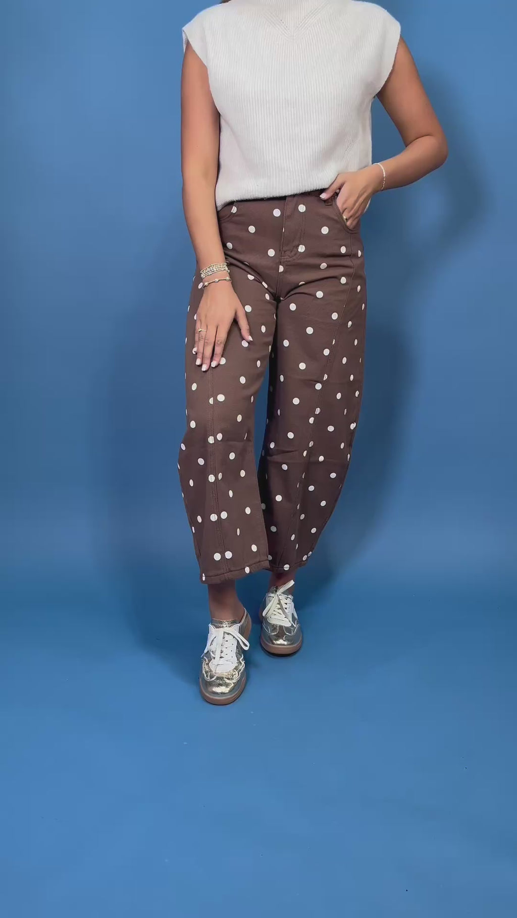 Chocolate brown high-rise cropped wide leg jeans with an allover ivory polka dot print, front pockets, and seam detailing.