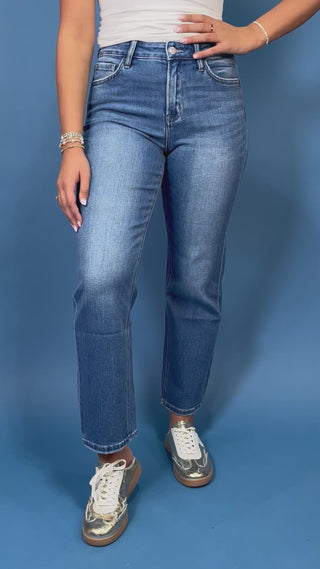 Medium wash high-rise straight leg jeans with subtle fading, a clean hem, classic five-pocket styling, and an ankle-length fit.