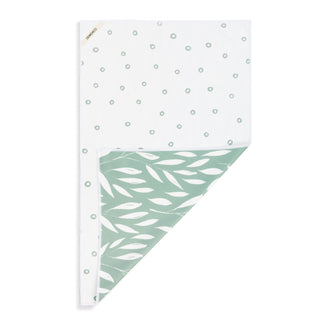 Notebook with white cover and green leaf pattern on a white background