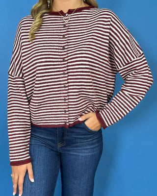soft textured knit, classic stripes, decorative buttons, and a relaxed fit for cozy