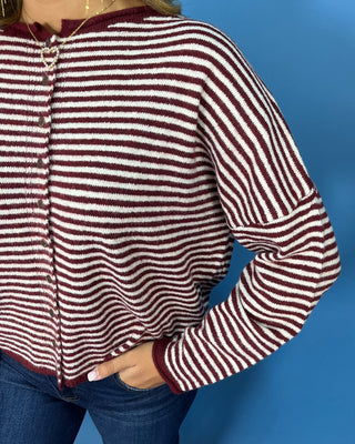 soft textured knit, classic stripes, decorative buttons, and a relaxed fit for cozy