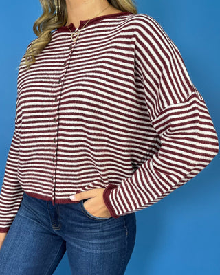 soft textured knit, classic stripes, decorative buttons, and a relaxed fit for cozy