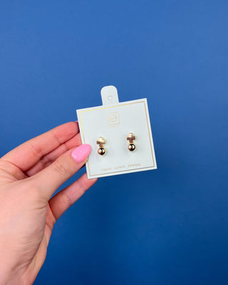 eNewton Signature Cross Gold Stud Earrings in classic gold featuring a polished gold ball with a cross accent and secure post backs, lightweight faith-inspired earrings displayed on an eNewton jewelry card.