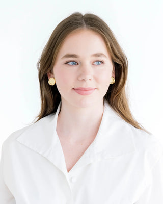 Woman wearing a white blouse with a plain background