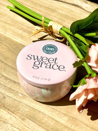 Jar of 'sweet grace' on a wooden surface with flowers