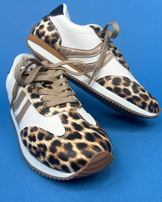 A pair of low-top sneakers featuring a leopard print pattern on the toe and eyestay panels, white leather overlays, a