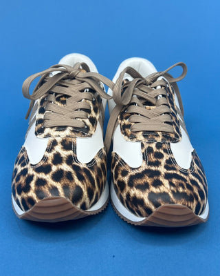 A pair of low-top sneakers featuring a leopard print pattern on the toe boxes, white side panels, and brown laces, shown aga