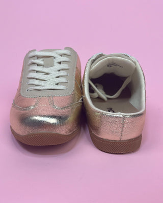 Metallic gold lace-up sneakers with a shiny textured finish, cream accents, white laces, and gum rubber soles.