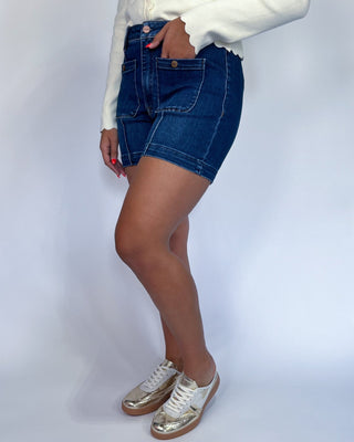 The shorts are dark blue with contrast stitching and feature front patch pockets.