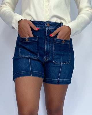 The shorts are dark blue with contrast stitching and feature front patch pockets.